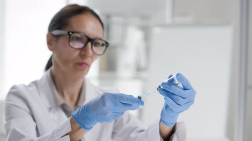 Woman Preparing Syringe in Medical Laboratory