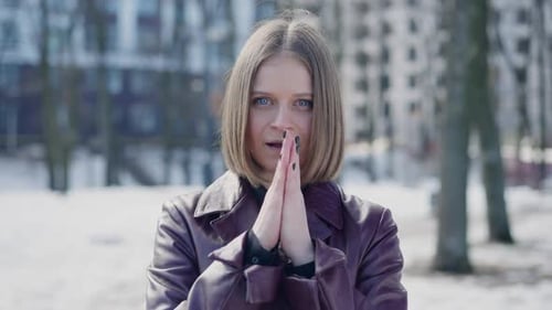 Live Camera Zoom in to Confident Millennial Caucasian Woman Breathing on Hands on Winter Day