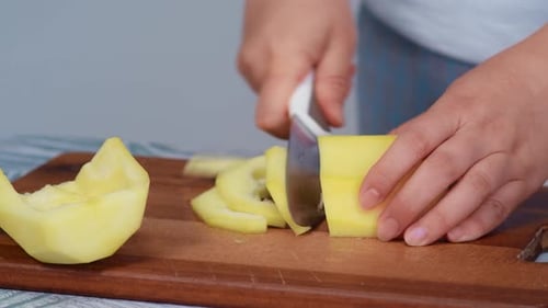 Housewife Knife Cuts Zucchini