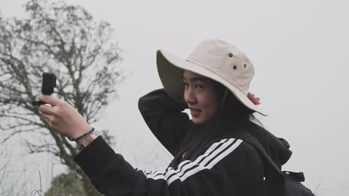 Young Adult Recording Themselves Outdoors