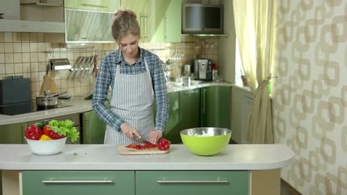 Woman Chopping Vegetables for Salad in Kitchen