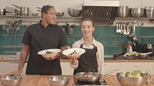 Chef and Student Presenting Pasta on Camera
