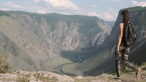Young Girl Tourist with Long Hair Comes To the Peak of the Mountain and Raises Her Hands Up. Goal