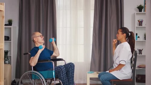 Man in Wheelchair Doing Arm Exercises with Therapist