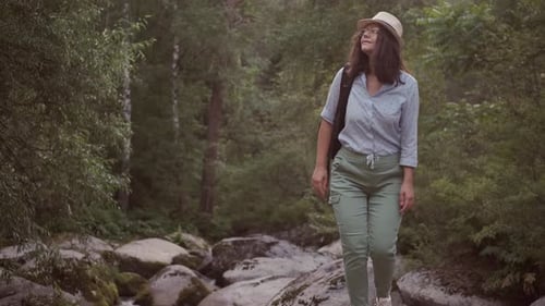 Woman Hiking Through Green Forest Nature Trail