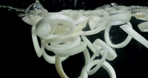 Onion Rings Falling into Clear Water