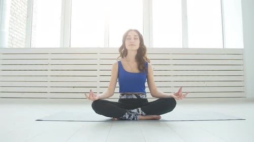 Woman Meditating in Lotus Position