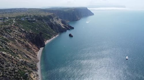 Aerial View From Above on Calm Azure Sea and Volcanic Rocky Shores