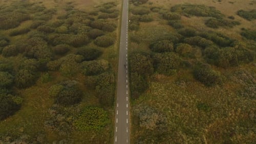 Aerial Shot of Motorcycle Taking the Scenic Route By the Countryside Road