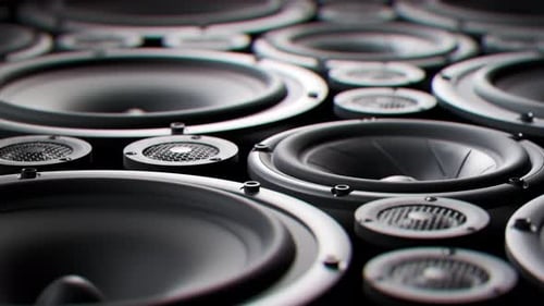 Vibrating speaker membranes stacked in endless loop. Lit by studio lights. 4K HD