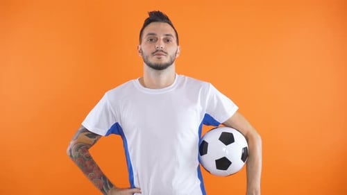 Young Adult Man Holding Soccer Ball