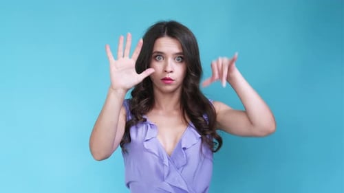 Attractive Woman Gesturing with Hands in Studio