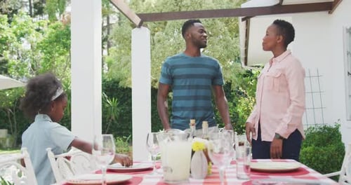 Family Prepares a Meal Outdoors on Sunny Day