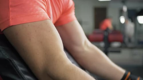 Muscular Man Lifting Weights at the Gym