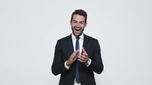 Man in Suit Smiling and Clapping Hands