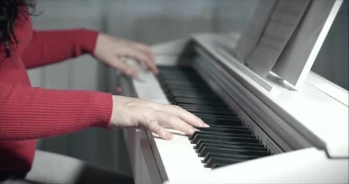 Woman Playing Piano Keys In a Home Interior