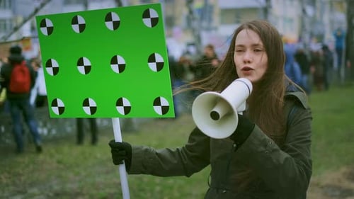 Young Woman Protests Holding Chroma Key Sign and Megaphone