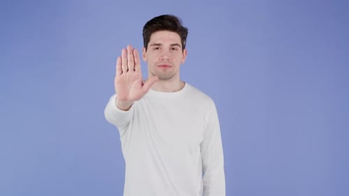 Portrait of Serious Man Showing Rejecting Gesture By Stop Palm Hand Sign