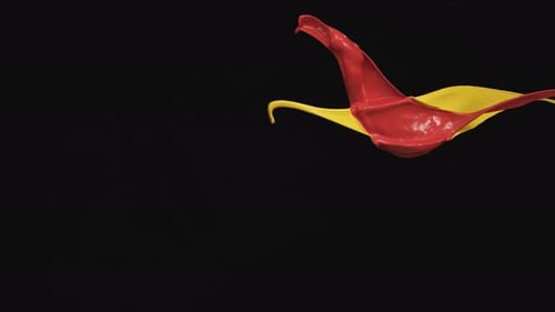 Dynamic Red and Yellow Paint Streams in Slow Motion