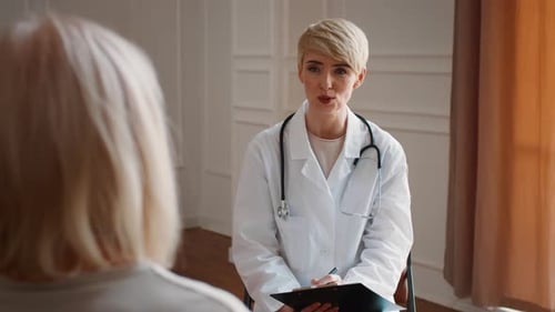 Female Doctor Consulting With Patient in Office