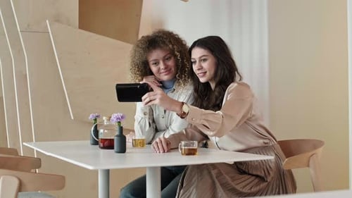 Two Young Women Making Selfie in Cafe