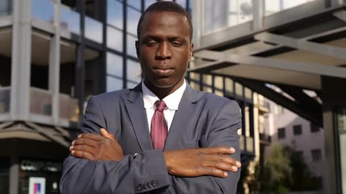 Confident and Serious Black Businessman Crossing His Arms Staring at Camera