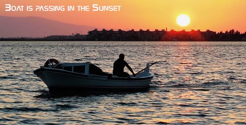 Sunset Waterway: Boat Silhouette Gliding Through Golden Waters