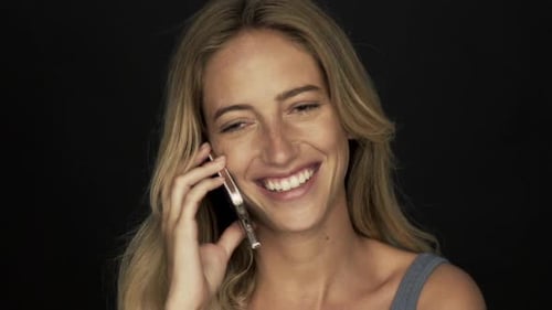 Smiling Woman Talking on Smartphone in Close-up