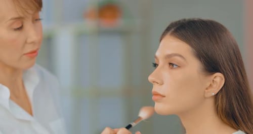 Beautiful Young Woman Doing Makeup in a Beauty Studio