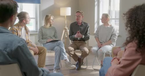 Close Up Group of Diverse People Talking and Sitting in a Circle During Group Therapy
