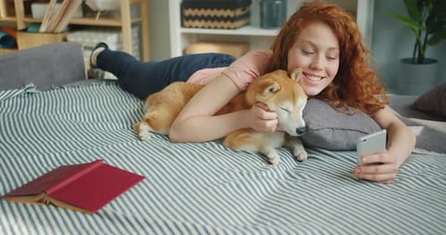 Woman with Dog Cuddling on Sofa Taking Picture