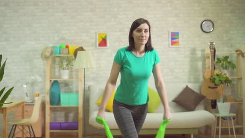Woman Exercising with Resistance Band at Home