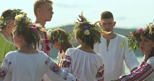 Adults in Traditional Clothing Dancing Together