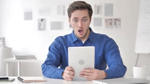 Young Adult Reacts in Surprise to Tablet Content