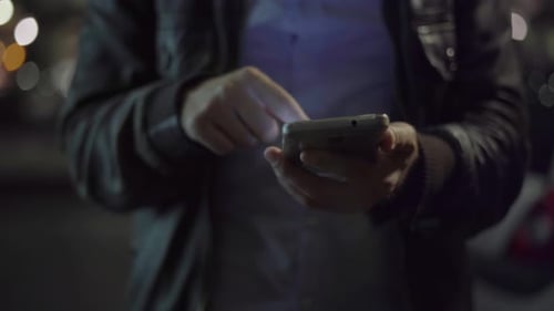 Adult Using Smartphone at Night in the City