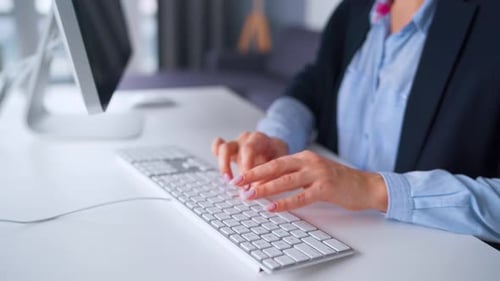 Adult Typing on a Keyboard in the Office