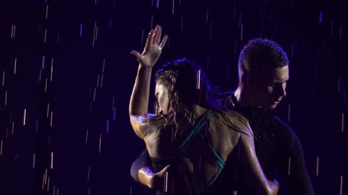 Ballroom Dancers are Dancing Passionate Bachata Dance in Pouring Rain