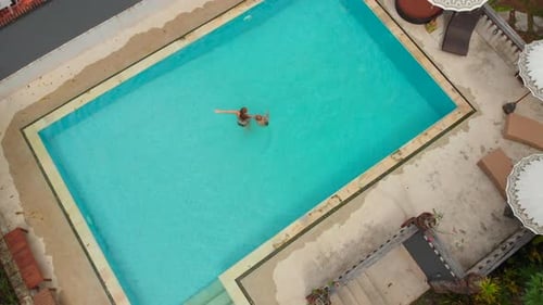 Luftaufnahme einer jungen Frau und ihres kleinen Sohnes Touristen, die eine gute Zeit in einem Schwimmbad in einem
