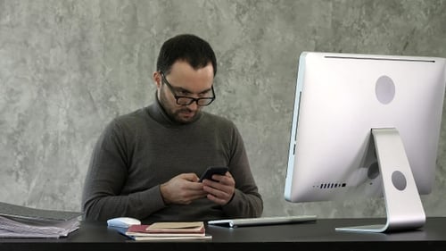 Bearded young businessman working at modern office. Man