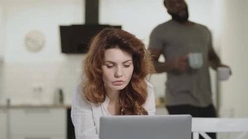 Couple Working Together on Laptop at Home