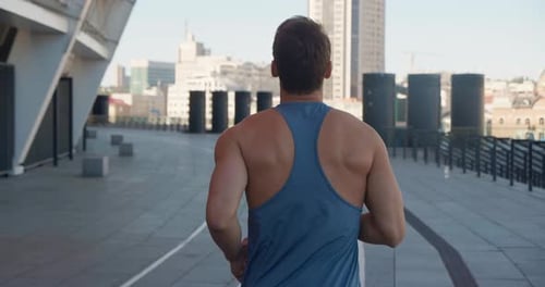 Rear Back View of Handsome Sport Man Running Outdoors