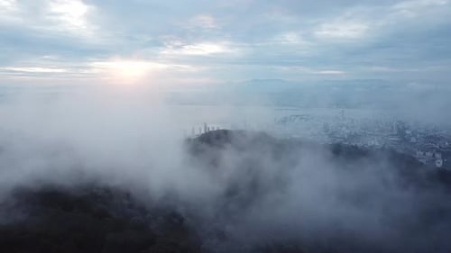 Aerial fly through foggy cloud reveal the George Town