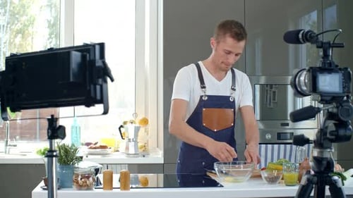 Man Cracking Eggs in Kitchen for Recipe Vlog