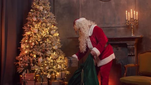 Santa Claus Pulling Presents From Green Bag