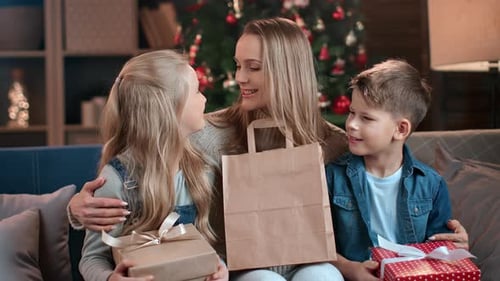 Family Celebrates Christmas with Gifts at Home