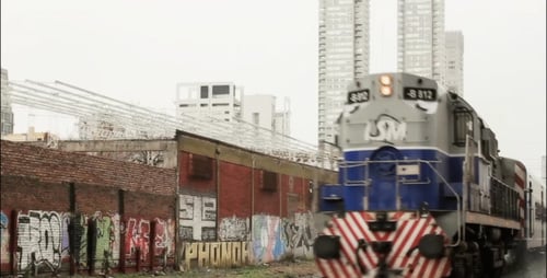 Night Train Travels Along City Tracks