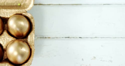 Close-up of golden Easter eggs in the tray