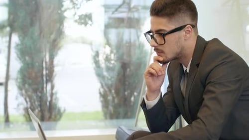 Businessman Using Laptop when Working on Project