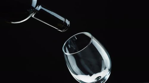 Bottle and Glass on Black Background