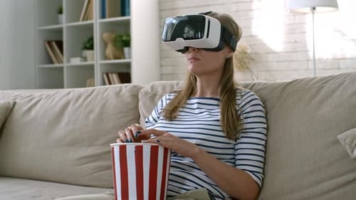 Woman Enjoys VR with Popcorn at Home